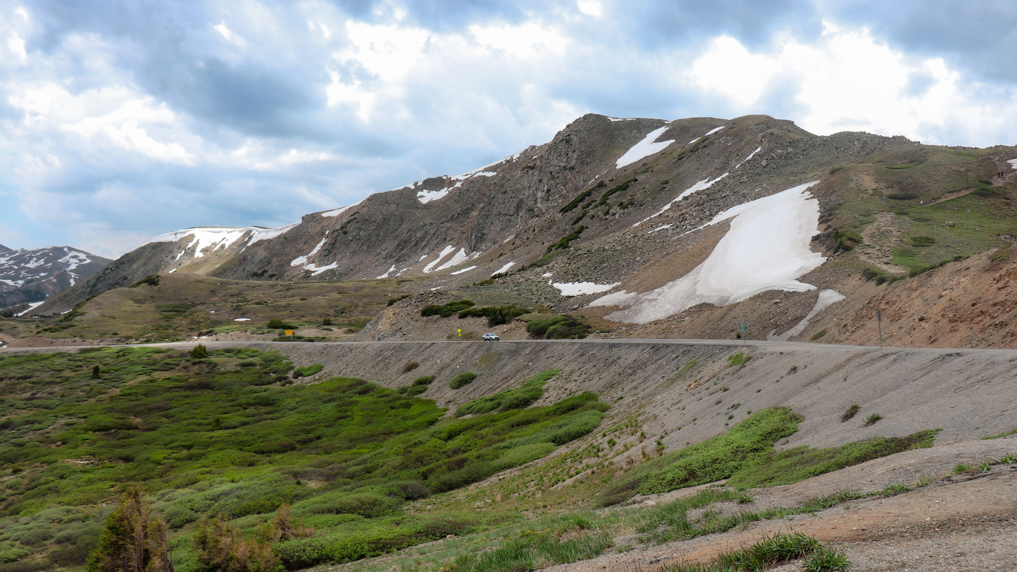 At altitude, many peaks lay bare the simple brutalism of jagged rock, juxtaposed against grasses, which bring life to even the harshest of conditions.